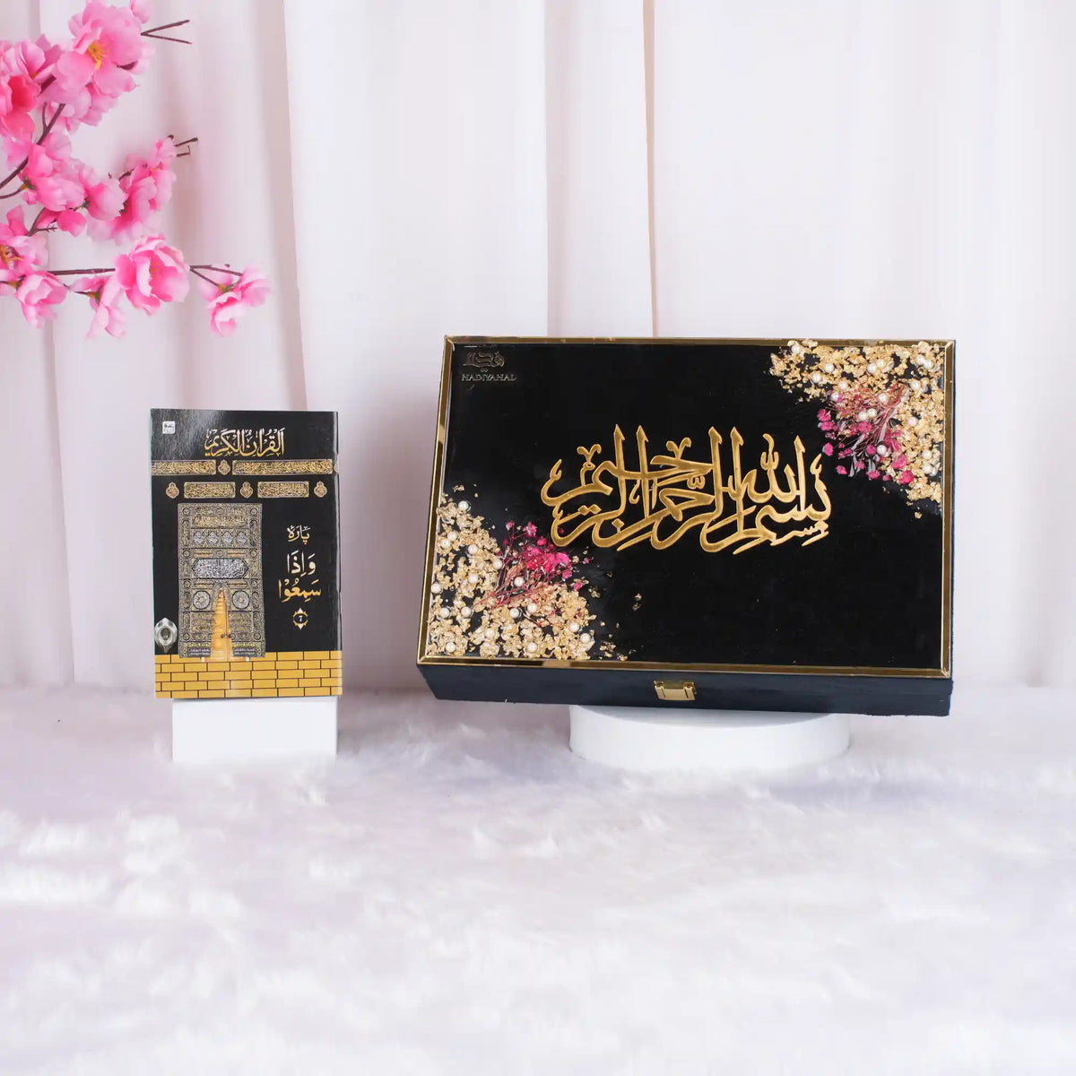 Quran book with decorative cover and pink flowers
