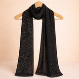 Black studded hijab with shimmering accents displayed on a hanger, highlighting its elegant drape and versatile styling for scarves and shawls.