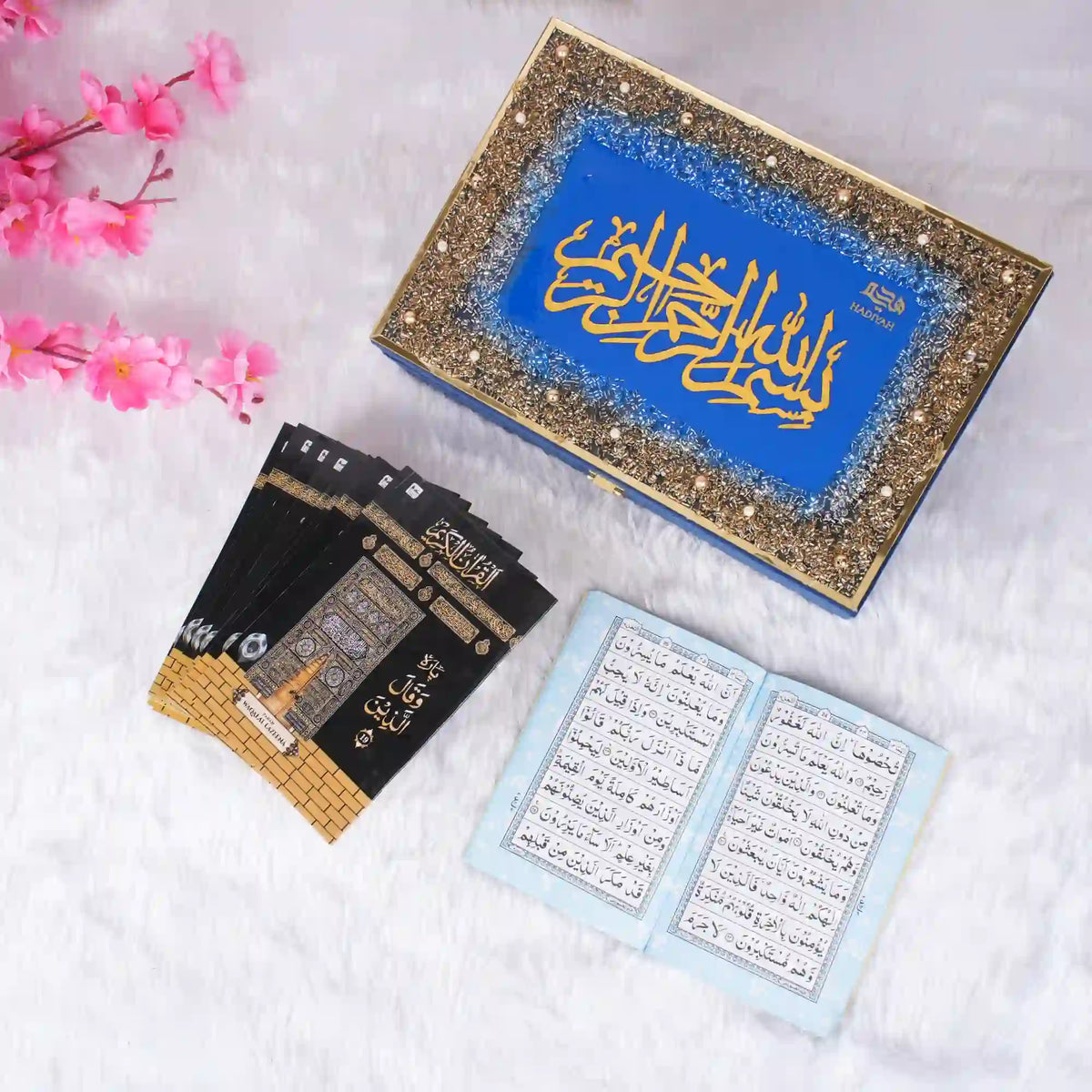 Black Quran box with gold Islamic architecture design and pink flowers