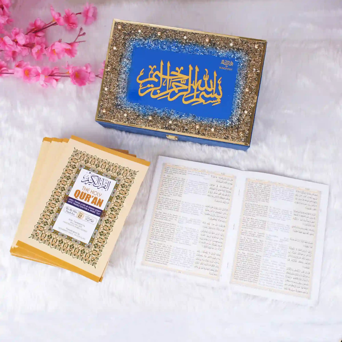 Blue Quran box with gold Arabic calligraphy and pink flowers