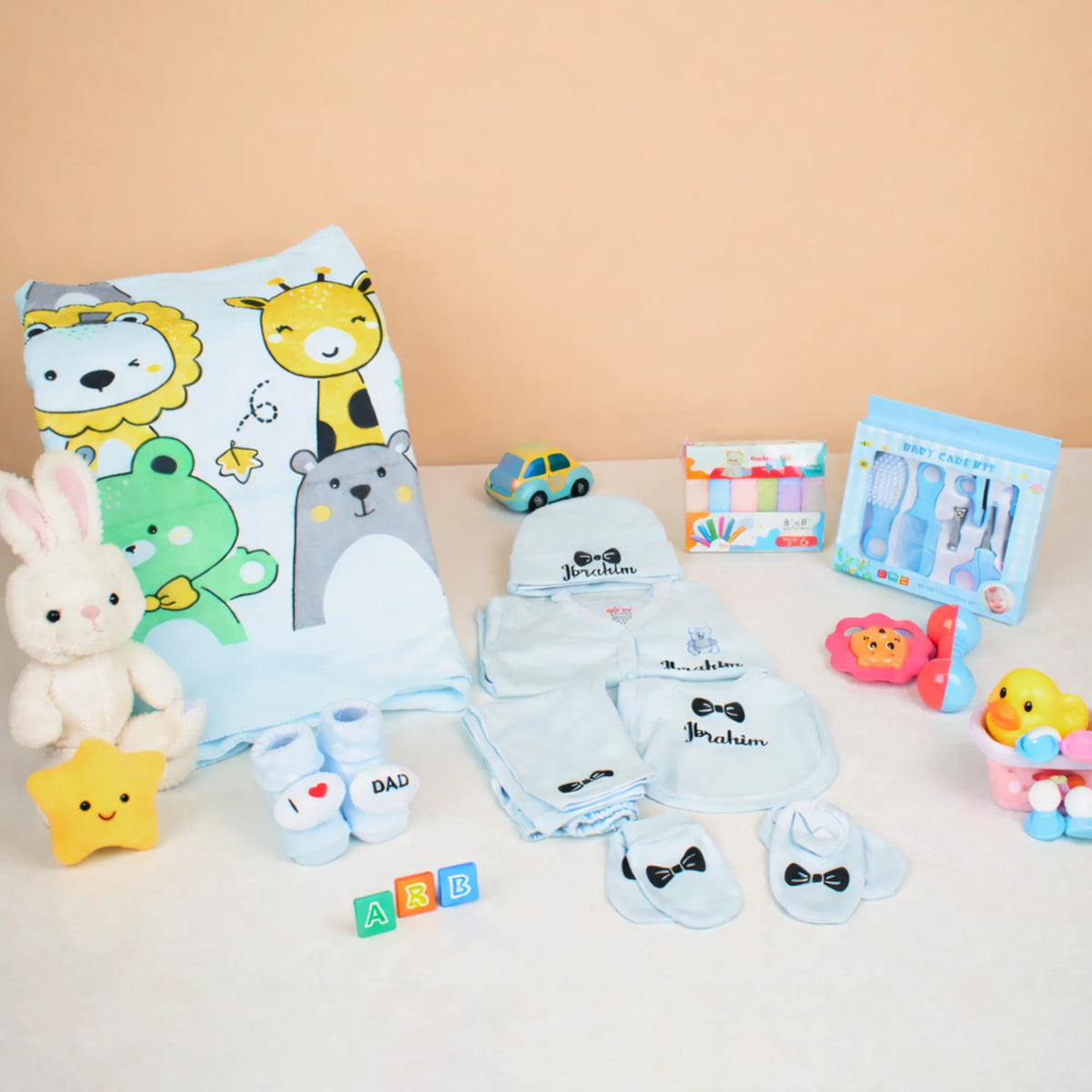 Baby Care Hamper - Baby Care set with blue animal blanket, custom babywear, grooming essentials, and toys for baby boys.