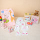 Baby Care Hamper - Baby Care gift set featuring pink animal print towel, grooming kit, personalized baby clothes, and plush toys for girls.