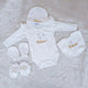 Baby clothing set with 'Fatima' embroidery on a soft surface