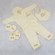 Yellow baby outfit set with matching accessories on a light gray background
