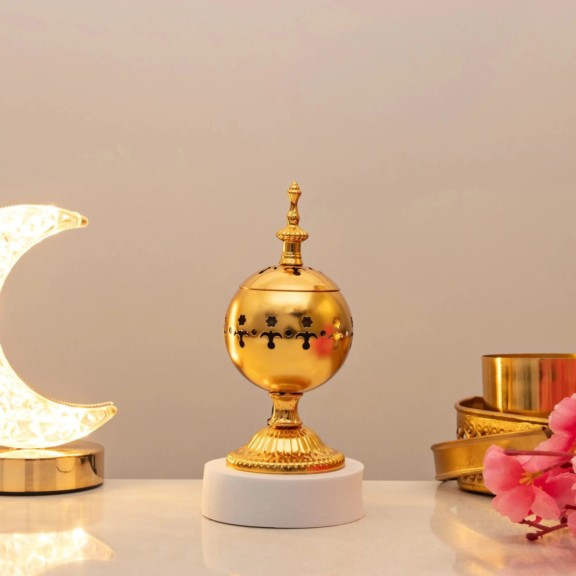 Serene Essence Bakhoor Burner - Premium gold spherical design with intricate cutouts, ideal for even scent distribution in home fragrance decor. Main image