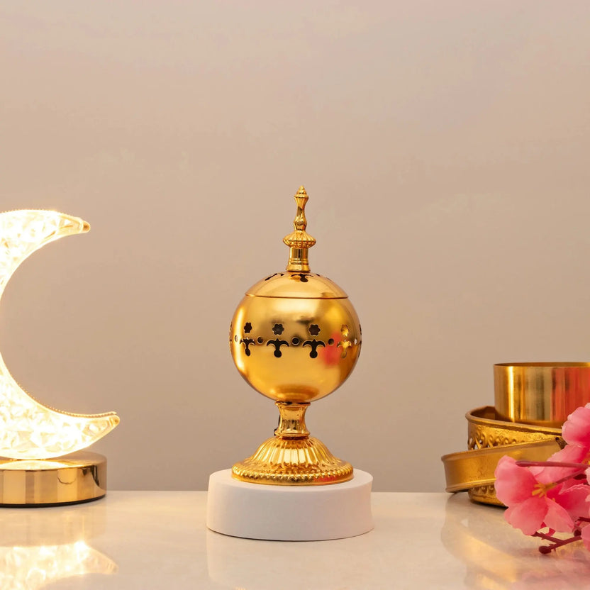 Serene Essence Bakhoor Burner - Premium gold spherical design with intricate cutouts, ideal for even scent distribution in home fragrance decor. Main image