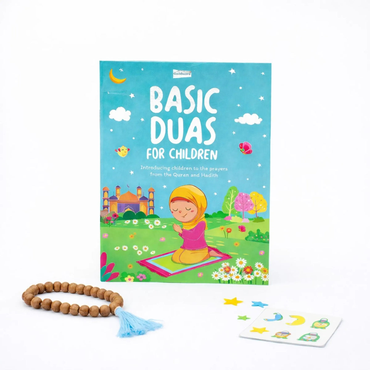 Cover of the "Basic Duas for Children" book featuring an illustration of a young girl praying, accompanied by a wooden tasbih with a light blue tassel and a small sheet of Islamic-themed stickers on a white background.