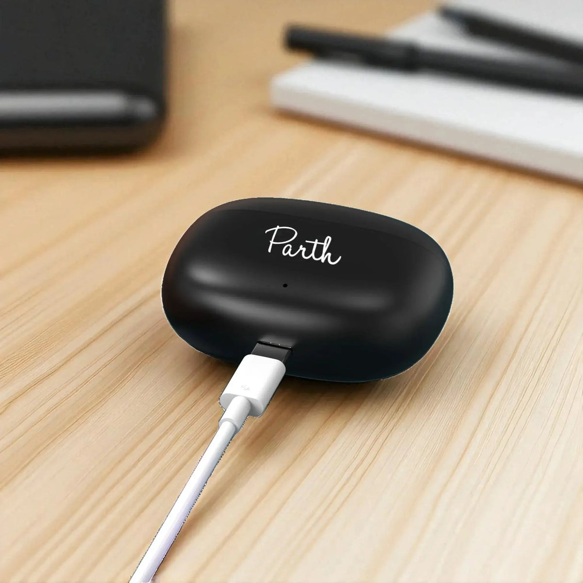 Berry Wireless Earbuds charging in compact black case with custom name, designed for seamless audio and portable convenience.