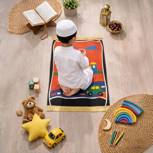 Kids Prayer Mat - Personalized Mat | Janamaz for Kids showing a boy praying on a road-themed mat with mosque and toy setup around.