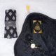 Black Sajdah Serenity Hamper flat lay featuring a black velvet janamaz, a mini black velvet Quran, a black crystal tasbeeh, and a rolled-up black and white printed prayer makhana.
