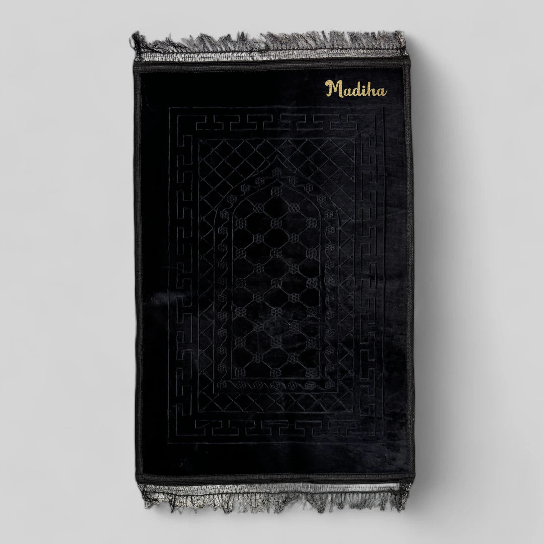 Personalized Black Janamaz with Name - Custom Black Prayer Rug embroidered with 'Madiha', made of plush velvet, ideal for religious gifting.