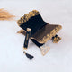 Black and gold Quran rehal with matching bookmark from the Sawab-e-Jariya Bridal Gift set. Decorative and functional Islamic gift.