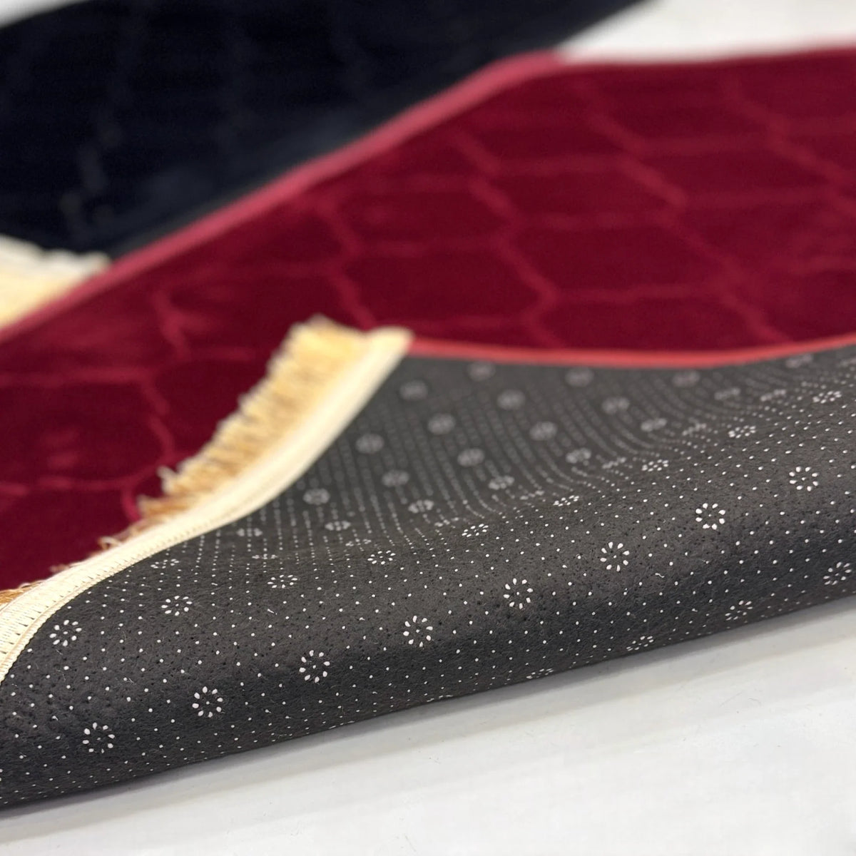 Underside of Black & Maroon Dome Couple Janamaz showing anti-slip dotted backing, combining comfort and safety in designer prayer mats.