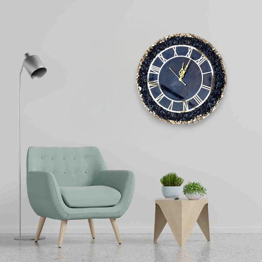 Black Grace Wall Clock featuring gold accents and crystal border displayed above a mint green chair. Elegant addition to modern interiors.