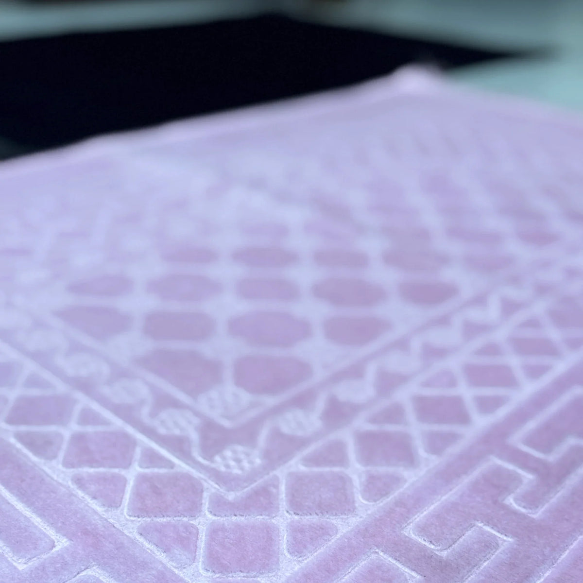 Detailed texture of pink prayer mat from Couple Janamaz Prayer Mat Set, highlighting soft velvet finish and geometric Islamic design.