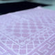 Detailed texture of pink prayer mat from Couple Janamaz Prayer Mat Set, highlighting soft velvet finish and geometric Islamic design.