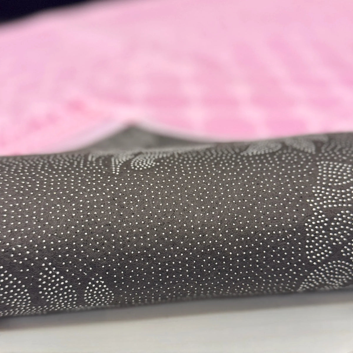 Close-up of designer pouch included with Couple Janamaz Prayer Mat - Black & Pink set, showcasing elegant dotted pattern for gift presentation.