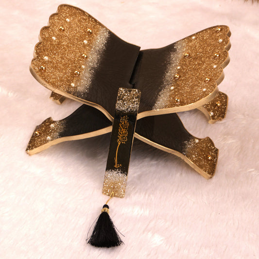 Handmade Quran Stand Set featuring a foldable resin Quran holder with gold and black glitter design and matching tassel bookmark. Ideal for prayer or gifting.