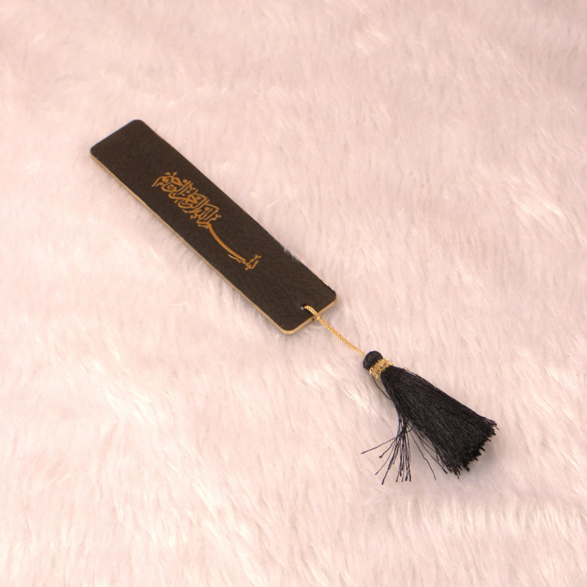 Black and gold Islamic bookmark with tassel from the Black Stones Rehal Hamper, designed for marking Quranic verses elegantly.