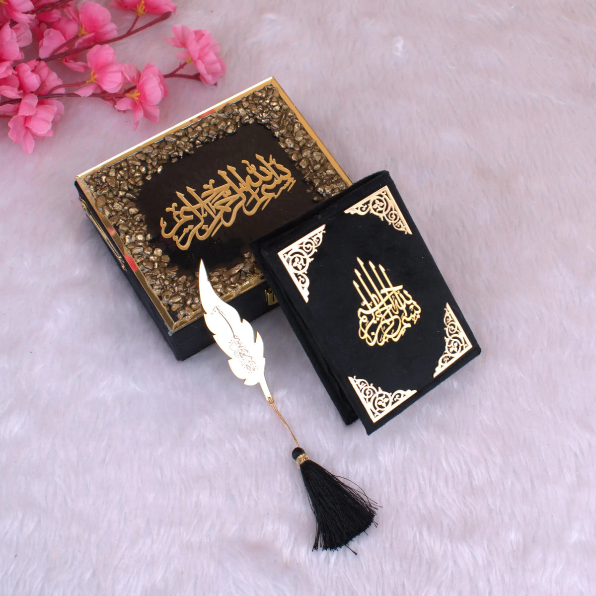 Black Stones Mini Tilawat-e-Quran with gold Arabic calligraphy, velvet cover, and decorative box. Includes elegant feather tassel bookmark.