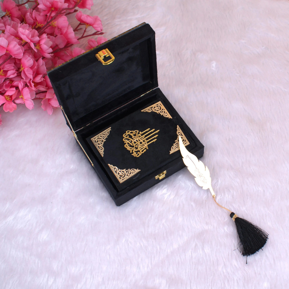Mini Quran Gift Set in black velvet with gold detailing, displayed in an open designer box with feather bookmark. Handmade in India, ideal for gifting.