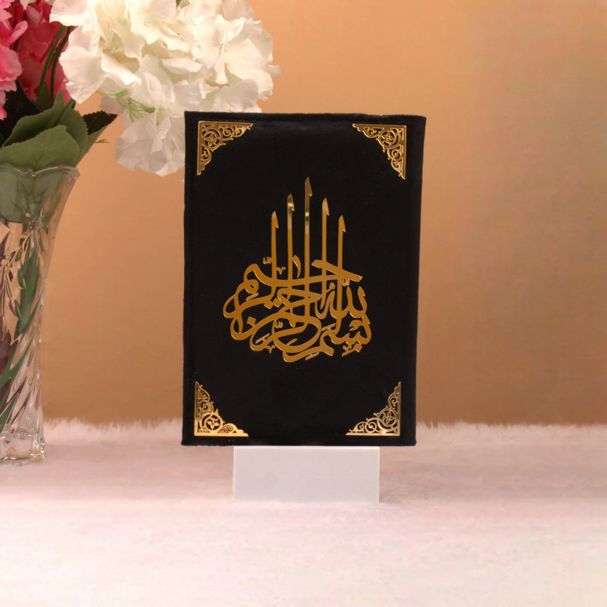 Velvet-covered Quran with golden Arabic calligraphy from the Black Stones Rehal Hamper, designed for spiritual and ceremonial gifting.