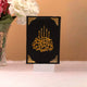 Velvet-covered Quran with golden Arabic calligraphy from the Black Stones Rehal Hamper, designed for spiritual and ceremonial gifting.