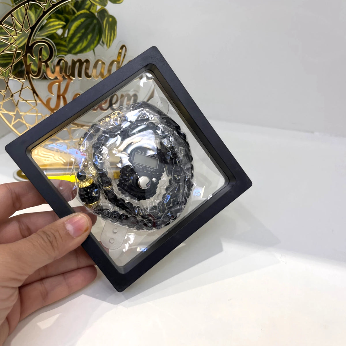 Black Tasbeeh Combo - Transparent Tasbeeh with 100-bead pearl prayer beads and digital counter in a black display box, ideal for Islamic gifting.