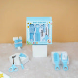 Baby care kit with tools and packaging on a textured surface