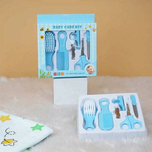 Baby care kit with tools and packaging on a beige surface