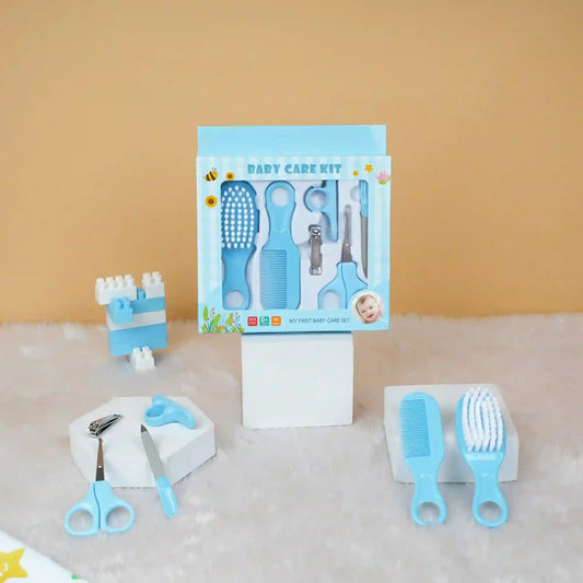 Baby care kit with tools and packaging on a textured surface