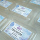 Aqiqah Meat Boxes Pack of 12 with custom labels for baby boy Ibrahim, ideal for hygienic distribution as wedding favors or food gift baskets.