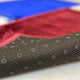 Non-slip backing of Blue & Maroon Janamaz Set with dotted grip pattern, ensuring stability during prayer on smooth surfaces.