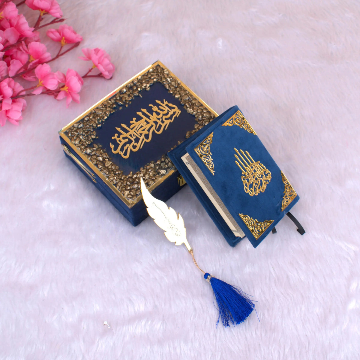 Blue Stones Mini Tilawat-e-Quran velvet gift set with gold detailing, compact Quran, and feather-shaped bookmark on soft pink background.
