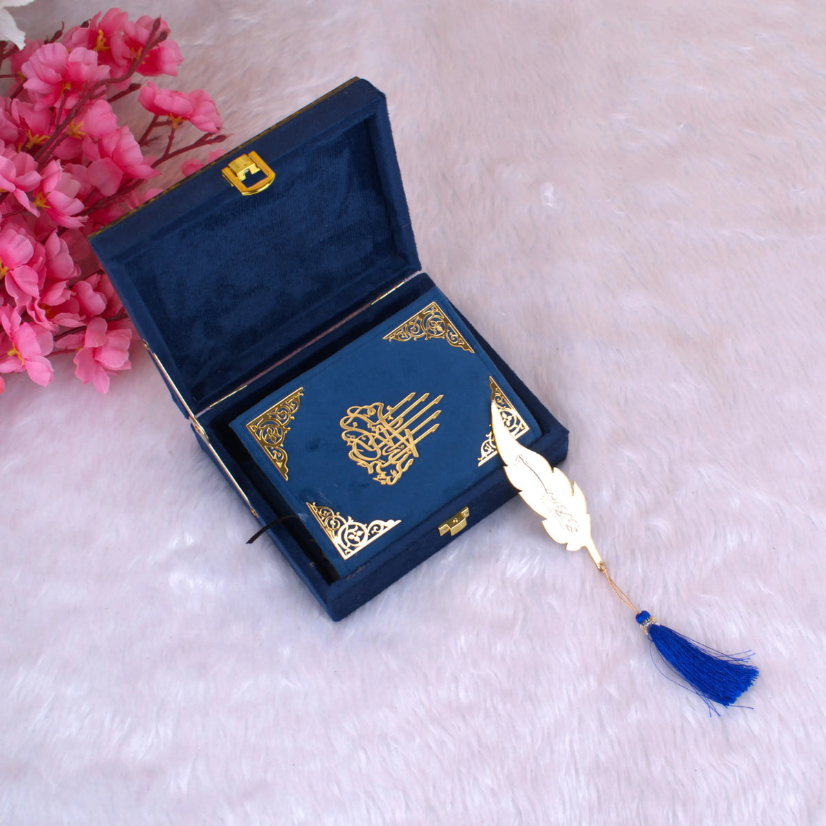 Compact Blue Stones Mini Tilawat-e-Quran inside an open velvet designer box with golden clasp and decorative feather bookmark.