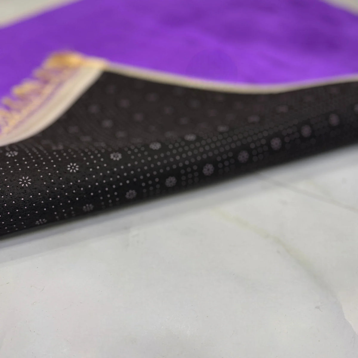 Close-up of the non-slip black underside of the Dome Prayer Mats from the Couple Janamaz Set, showing quality and durability.
