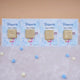 Row of Aqiqah Sweet Blessings Favors with gold-wrapped chocolates on blue personalized cards, great for Aqiqah event giveaways.