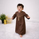 Baby boy in traditional brown thobe for Eid