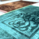 Close-up of Brown & Green Rectangle Janamaz - Couple Prayer Mats Set showing soft velvet texture and intricate Islamic patterns.