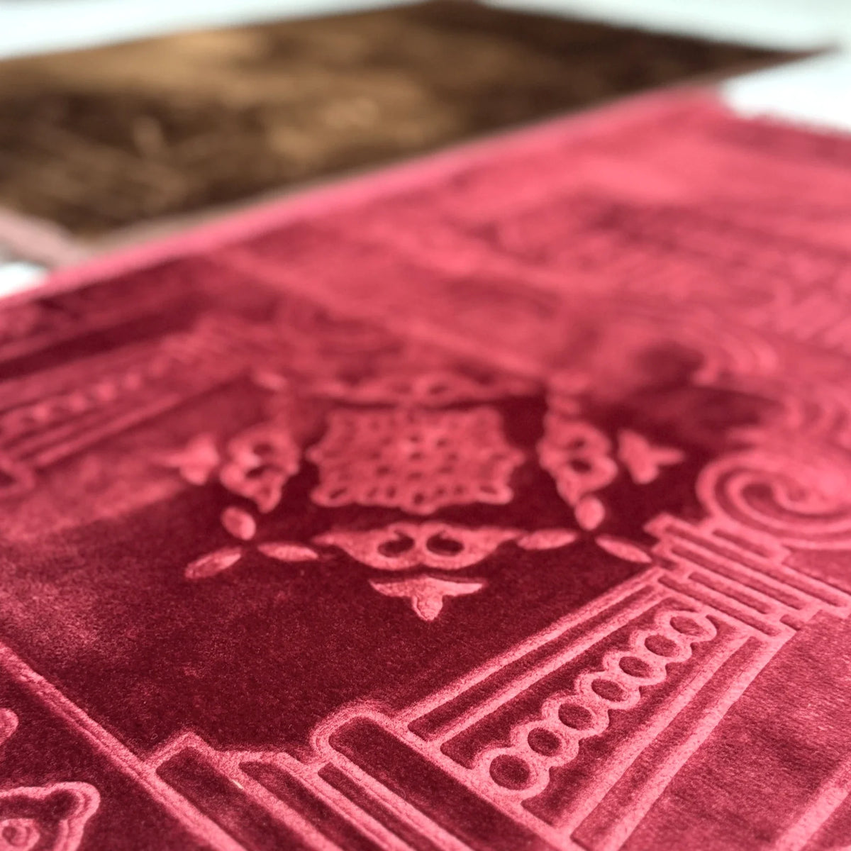 Detailed texture of Maroon Janamaz from the Brown & Maroon Couple Janamaz Set, showcasing intricate embossed patterns and plush fabric.