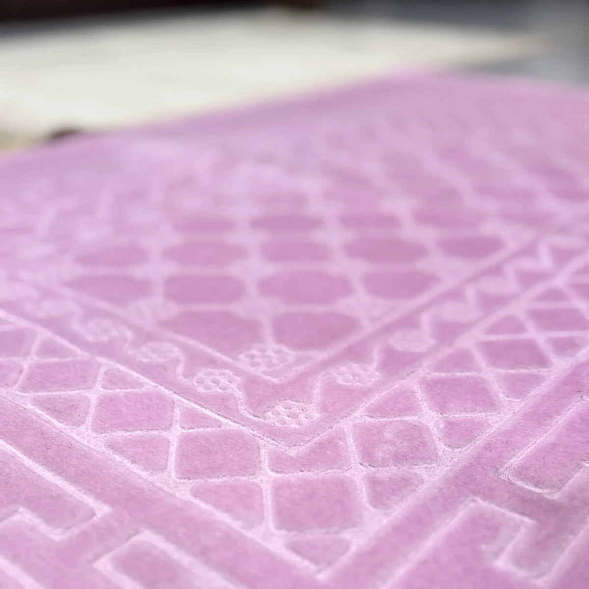 Detailed texture of pink rectangle Janamaz from the Couple Prayer Mats Set, made with soft premium fabric.
