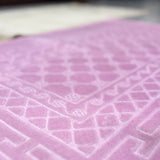 Detailed texture of pink rectangle Janamaz from the Couple Prayer Mats Set, made with soft premium fabric.