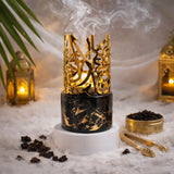 Elegant gold and black Bakhoor burner with intricate design for home fragrance