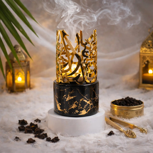 Elegant gold and black Bakhoor burner with intricate design for home fragrance