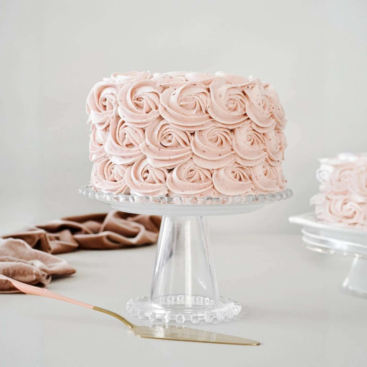 Pink Rosette Vanilla Round Cake sliced to show the layers inside