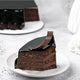 Slice of Chocolate Truffle Cake - Rich Indulgence showing moist chocolate layers and velvety ganache, ideal for dessert lovers.