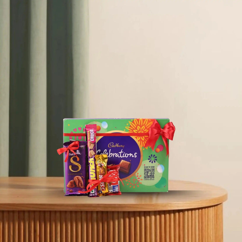 Assorted chocolate hamper with Cadbury Silk, KitKat, Munch, 5 Star, and Cadbury Celebrations tied with a red ribbon Main image