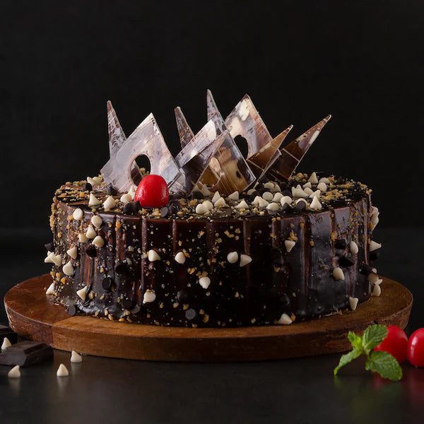 Marble Crunch Cake - Chocolate Vanilla Crunch with chocolate glaze, cherry topping, and white chocolate chips on a wooden base. Main image