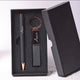 Open black gift box with engraved pen and keychain inside