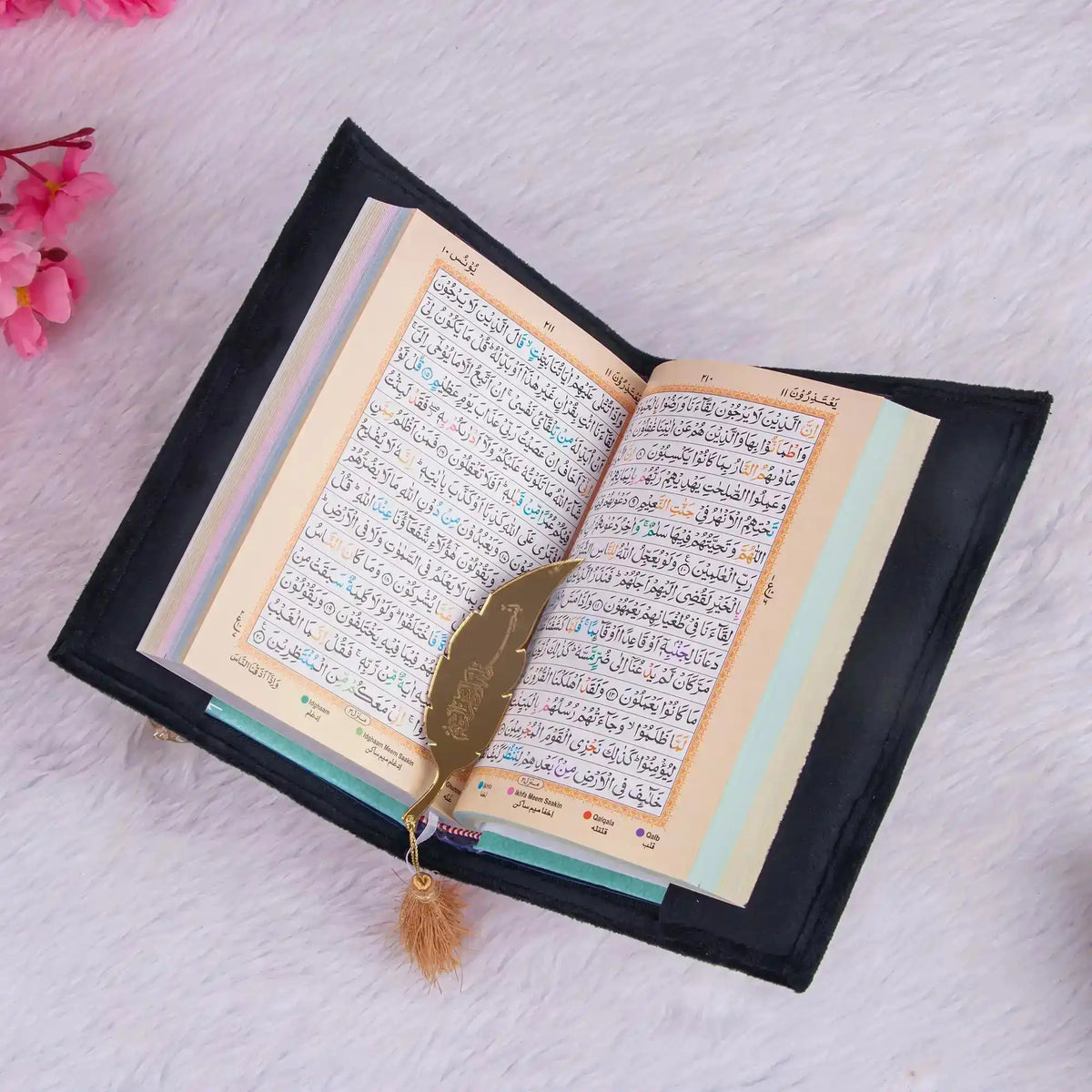 Color-coded Quran with golden feather bookmark from the Black Sequence Rehal Hamper - ideal for daily recitation.